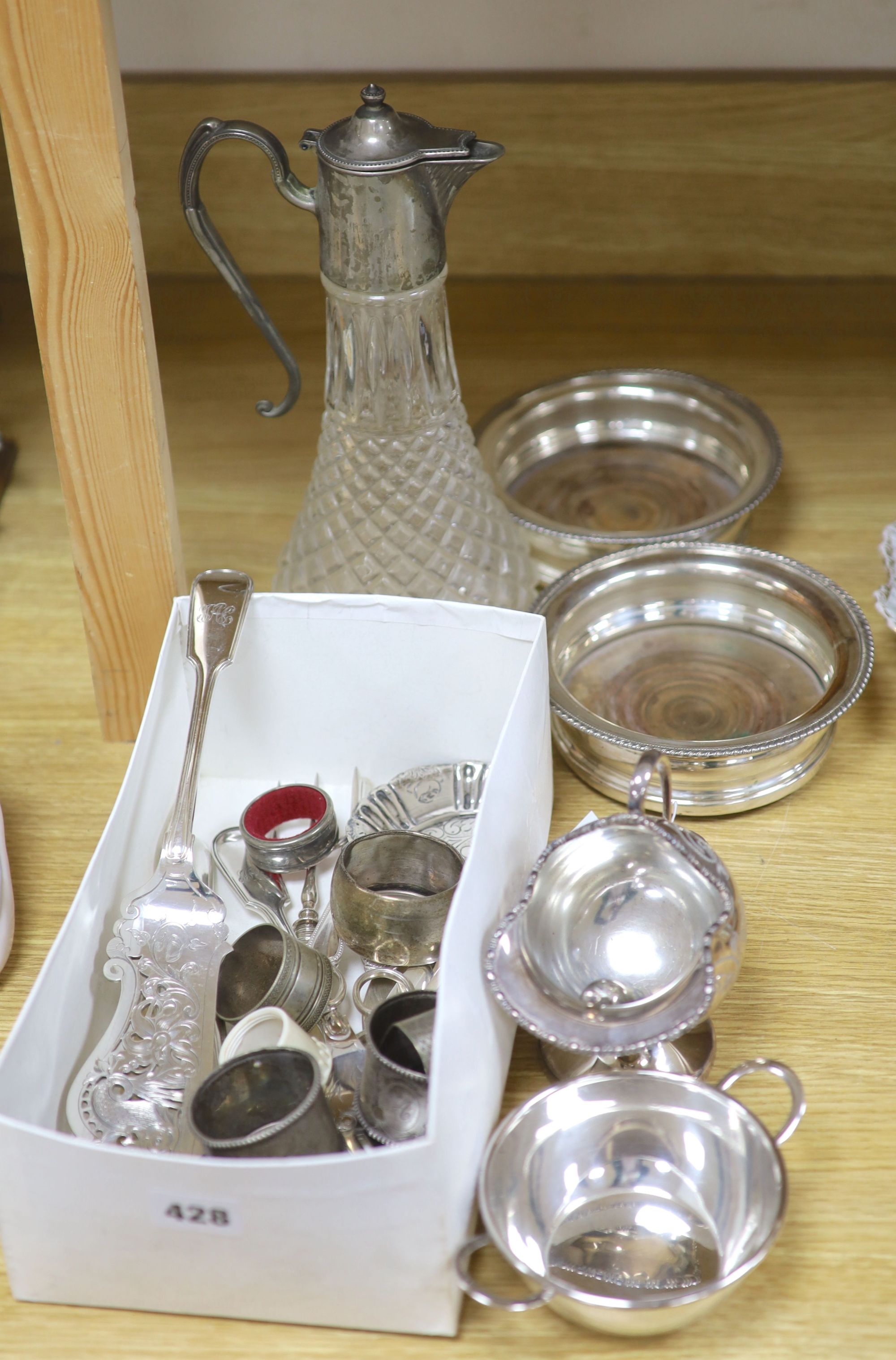 A group of mixed plated wares including a pair of wine coasters, 15.5cm, napkin rings, flatware, etc.